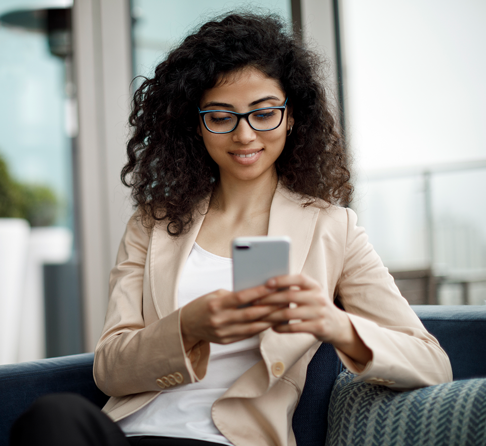 Photo of woman in sportcoat reading smartphone in hands